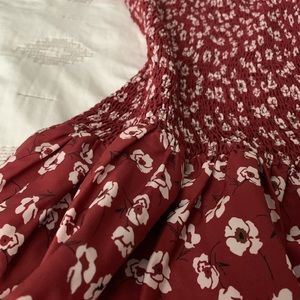 Shirred patterned mini dress with floral detail.